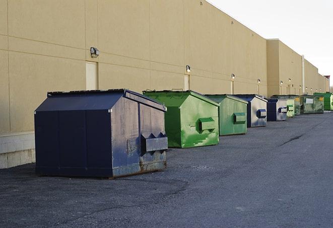 construction workers disposing of debris in large dumpsters in Aroma Park, IL